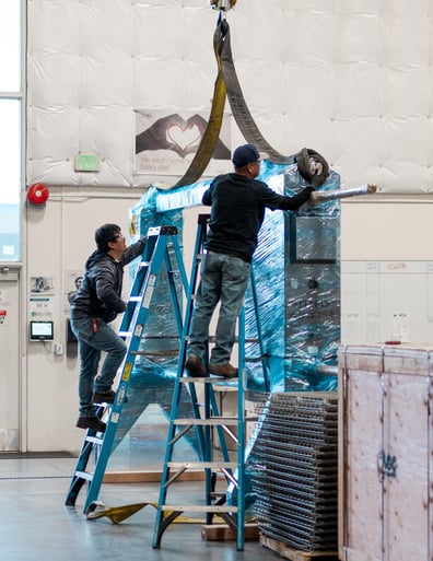 AGC team members prepare plate heat exchanger for shipping