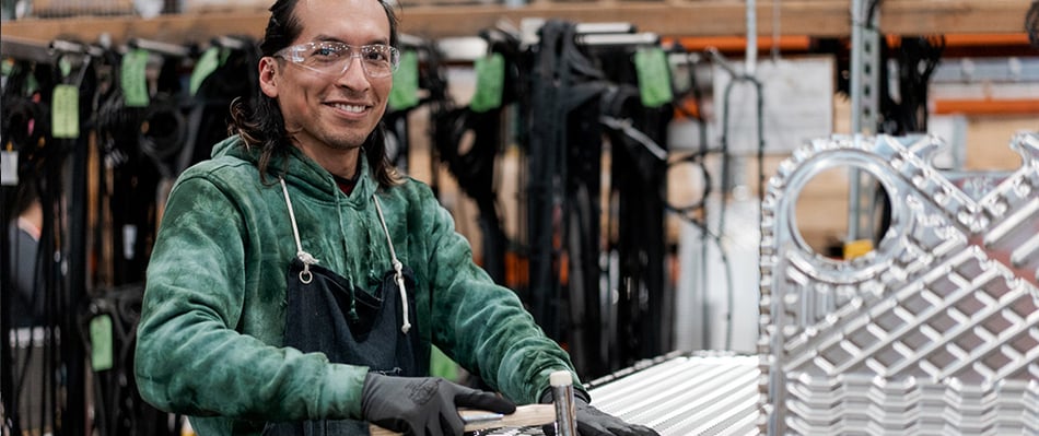 employee regasketing a plate